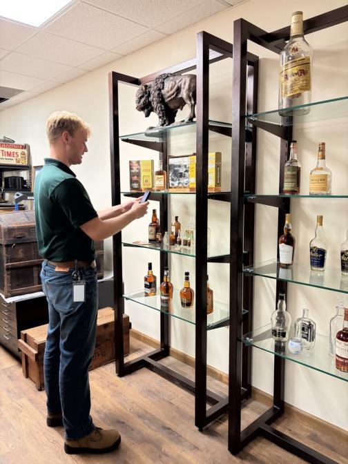 Jacob Crowley documenting displays in one of the archives office rooms.